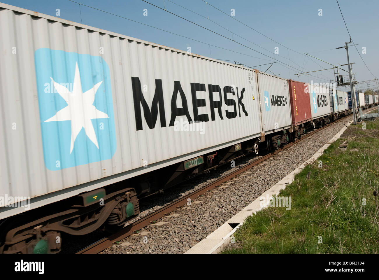 Freight containers on a train travelling along the english railway. Stock Photo