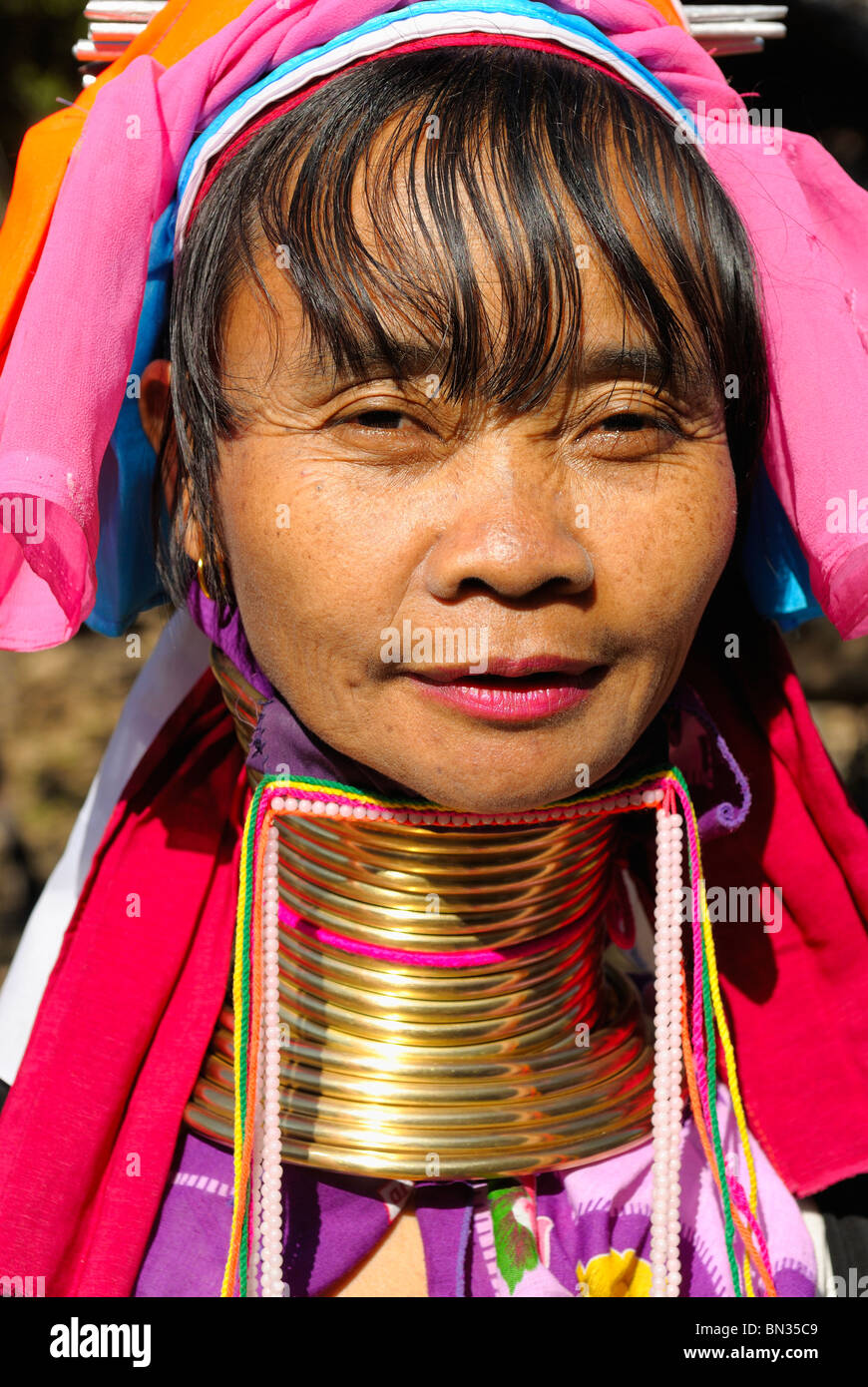 Woman with many brass rings around her neck hires stock photography