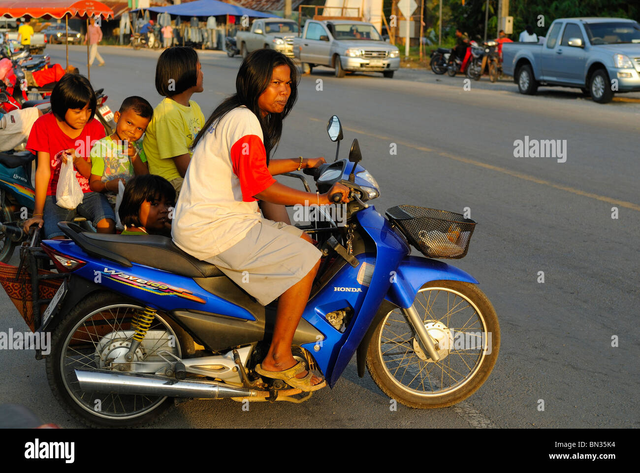 Thai woman riding a sidecar in a street of Baan Nam Khen village, West of Thailand Stock Photo