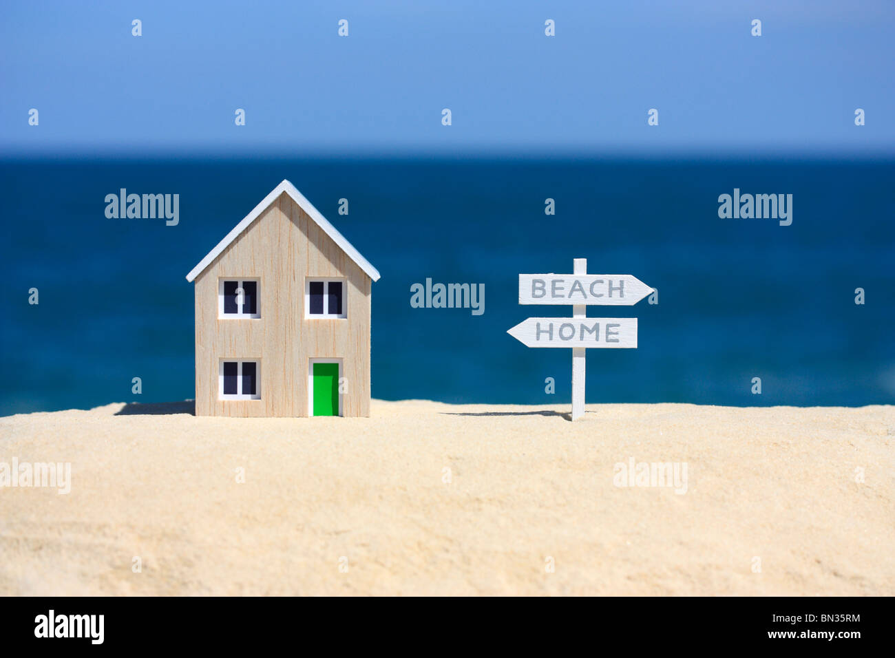 Model house and signpost Stock Photo