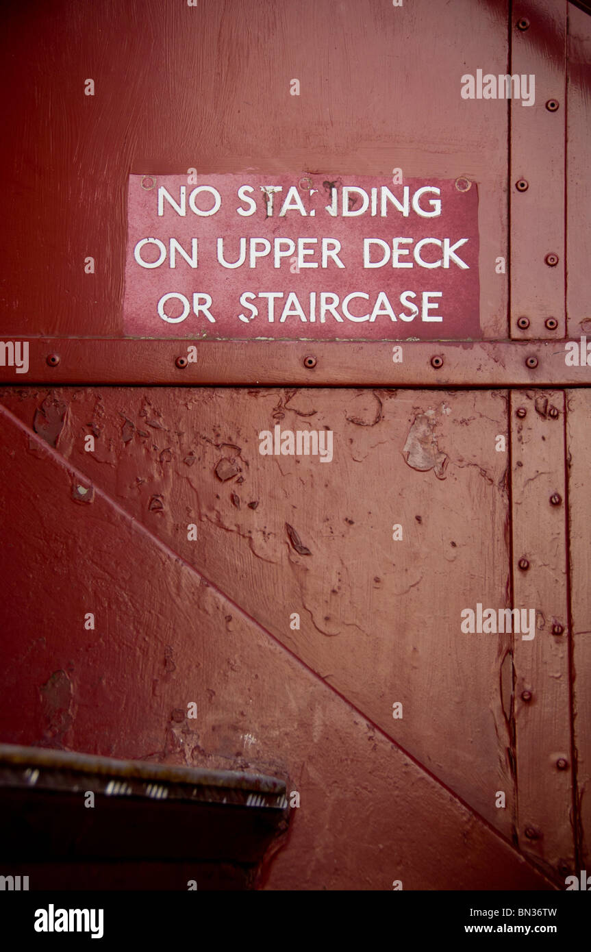 No standing on upper deck sign in a  vintage double decker bus Stock Photo