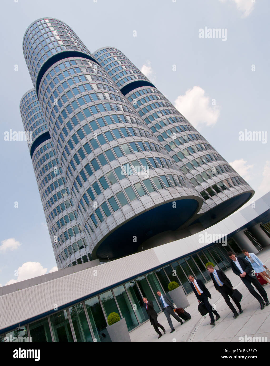 Business people walking outside the corporate headquarters of BMW in Munich, Germany. Stock Photo