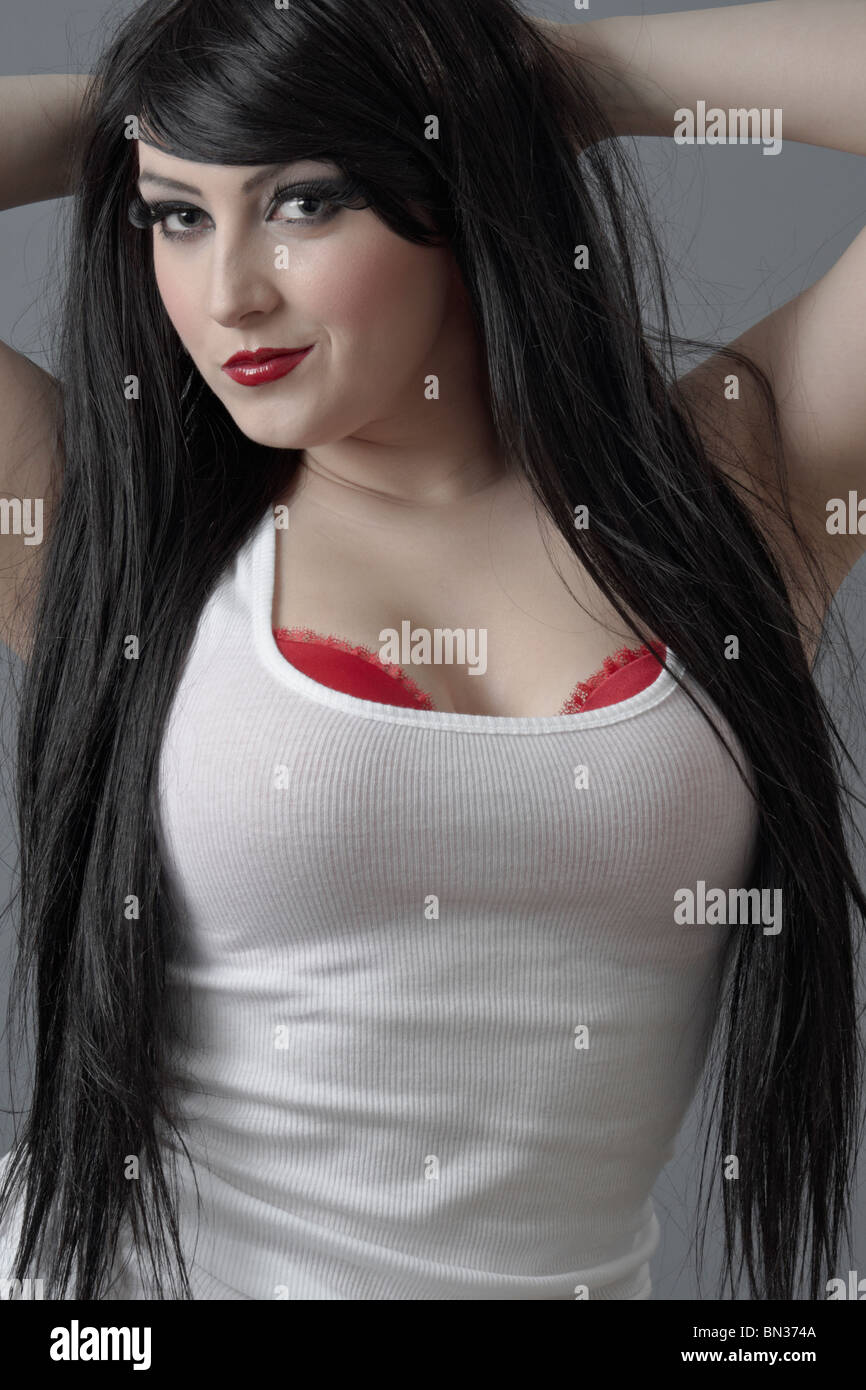 Young attractive beautiful woman with long black hair and a white top Stock Photo