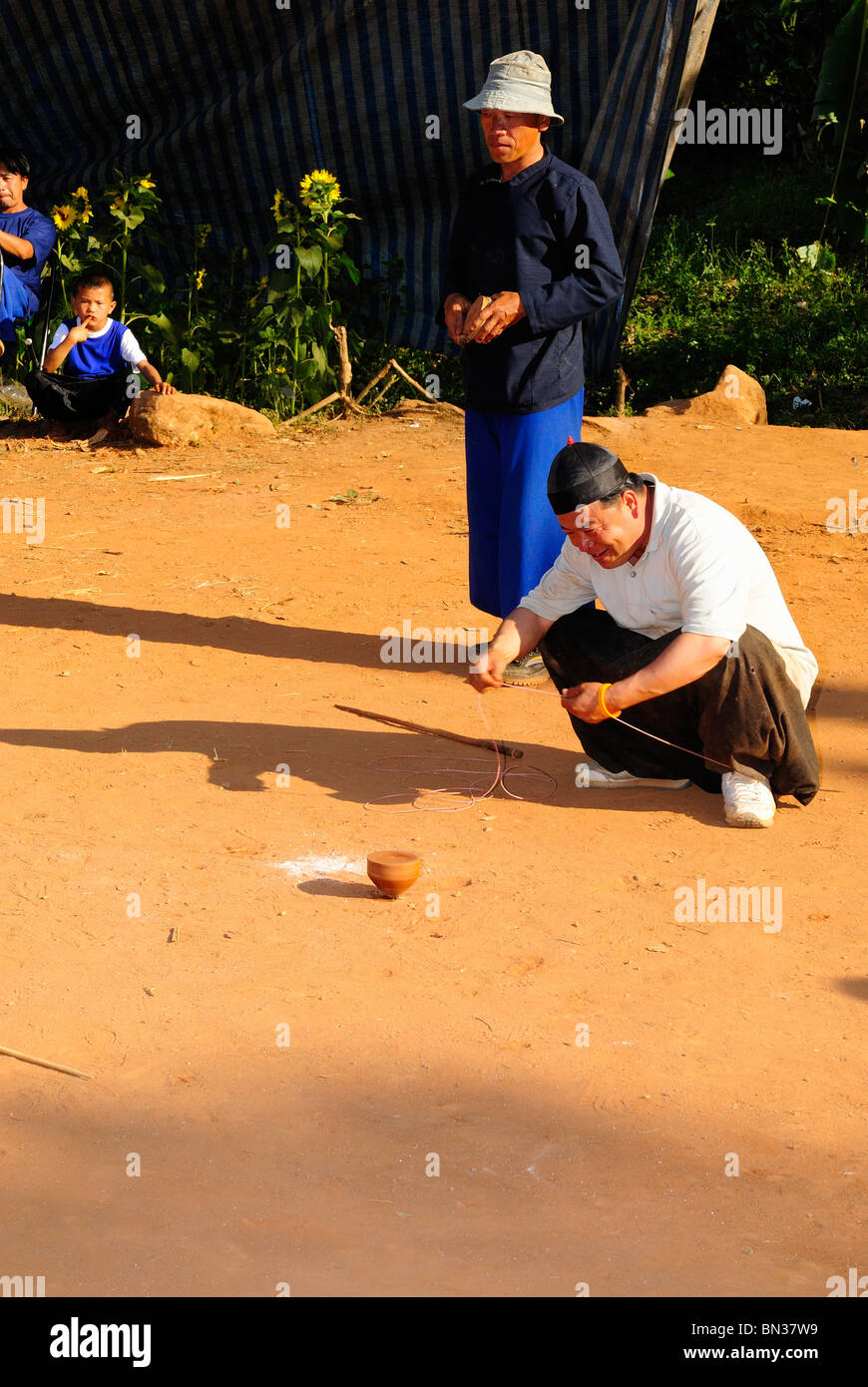 Hmong people playing top spinning during a tournament in Ban Phanok
