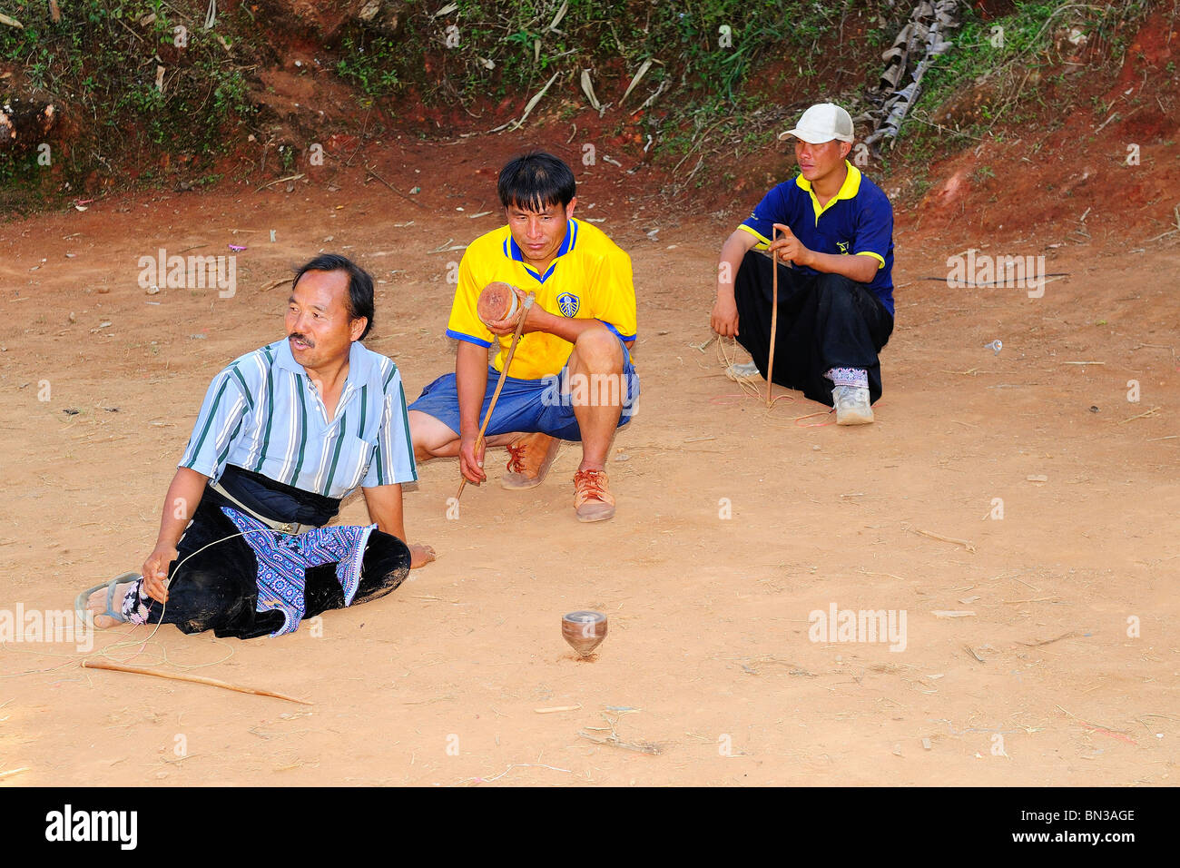 Hmong people playing top spinning during a tournament in Ban Phanok