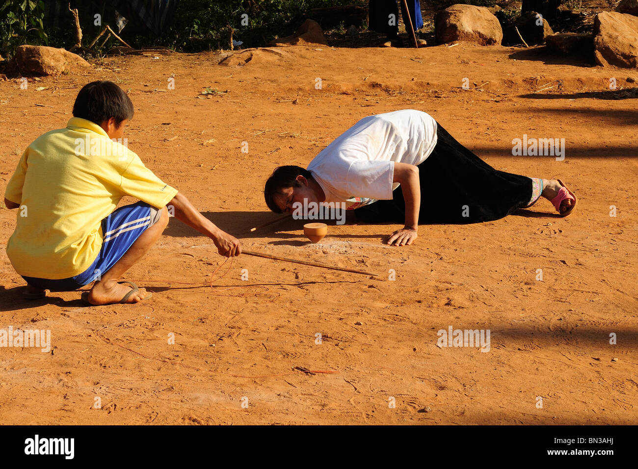 Hmong people playing top spinning during a tournament in Ban Phanok