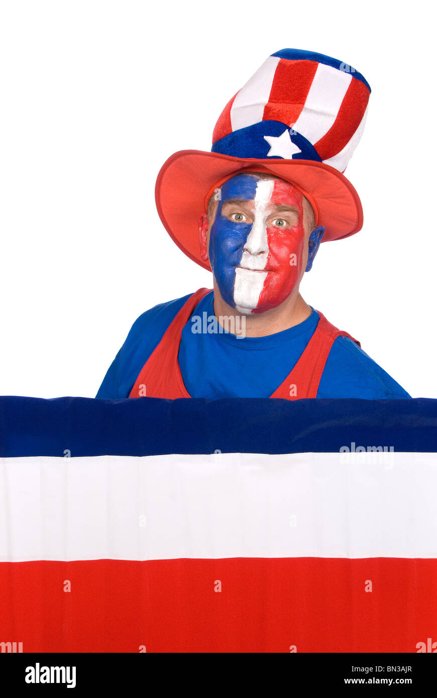 A patriotic man dressed in fourth of July attire and red, white and blue make up. Stock Photo