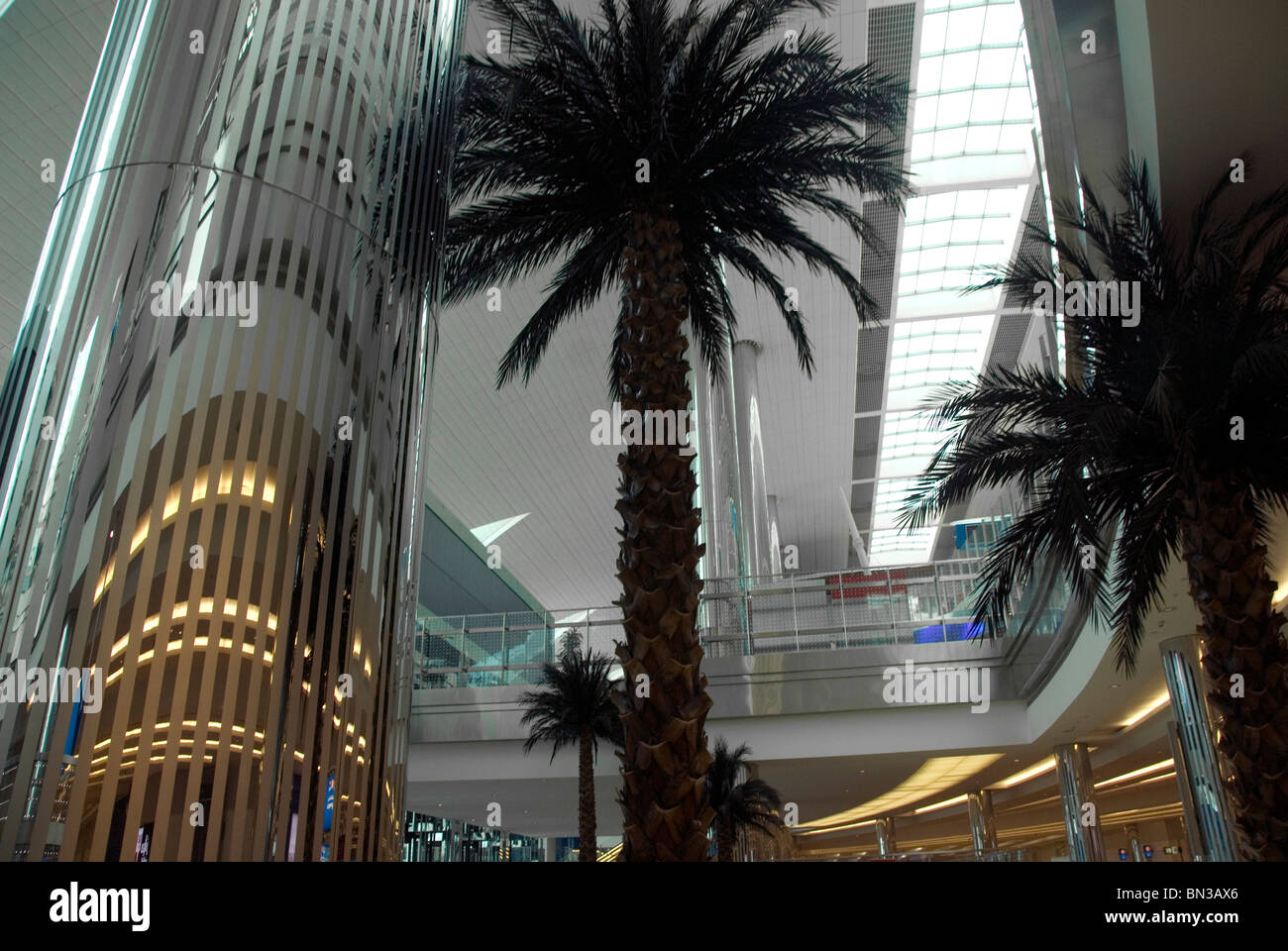 Dubai airport , artificial palm tree and reflective architecture Stock Photo Alamy
