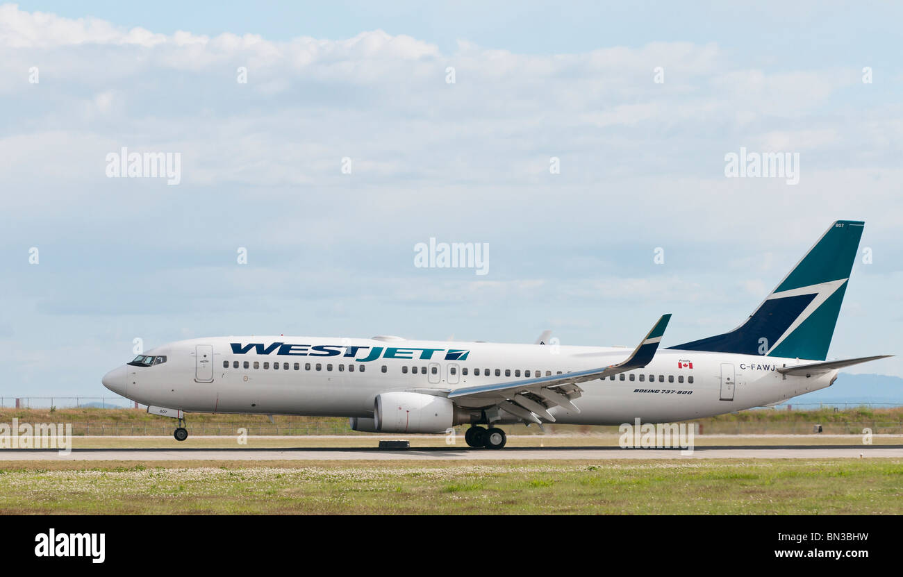 A Westjet Airlines Boeing 737-800 passenger jet landing at Vancouver International Airport (YVR). Stock Photo