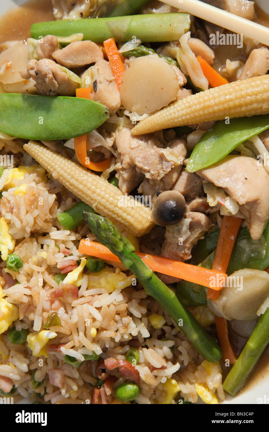 Chinese teriyaki chicken and vegetable stir fry meal with ham fried rice close-up Stock Photo
