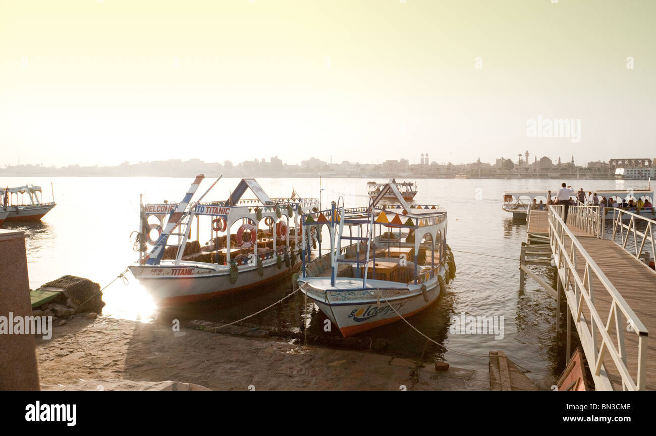 Ferry boats tied up on the banks of the river Nile, early morning, Luxor Egypt Stock Photo