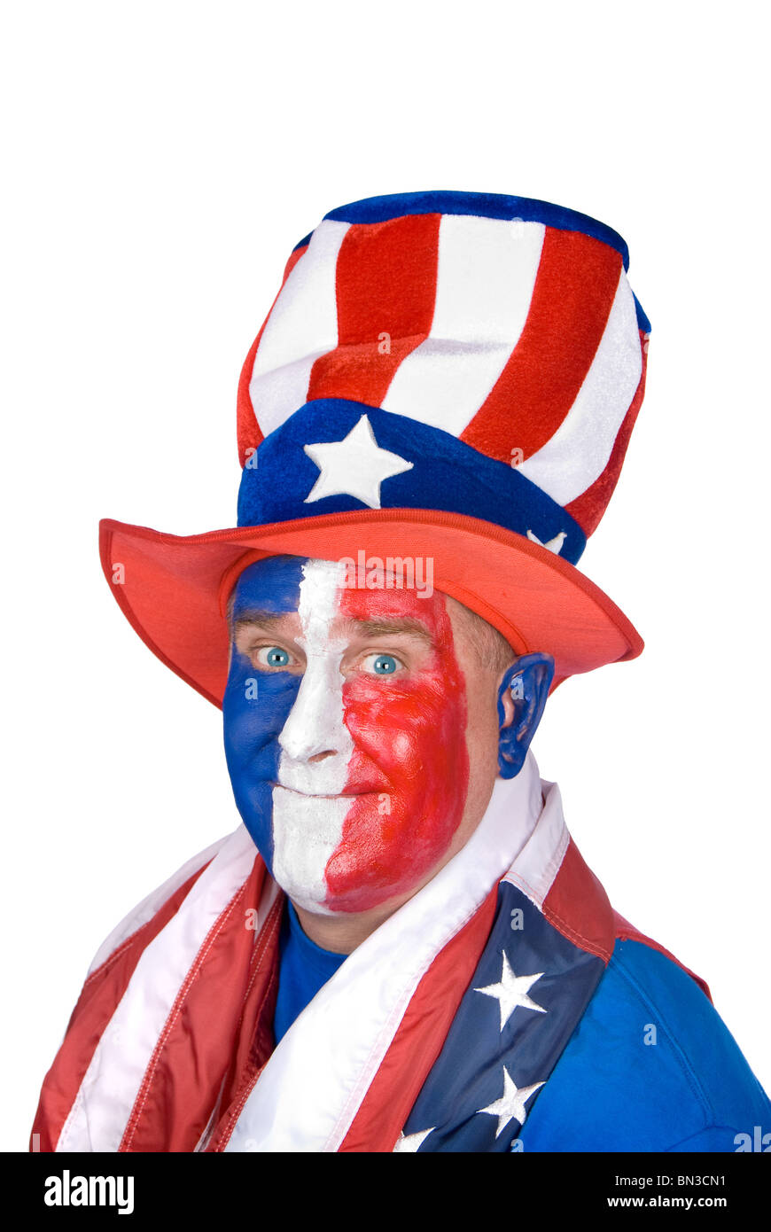 A patriotic man wearing red, white and blue face paint and color ful hat in celebration of the Fourth of July. Stock Photo