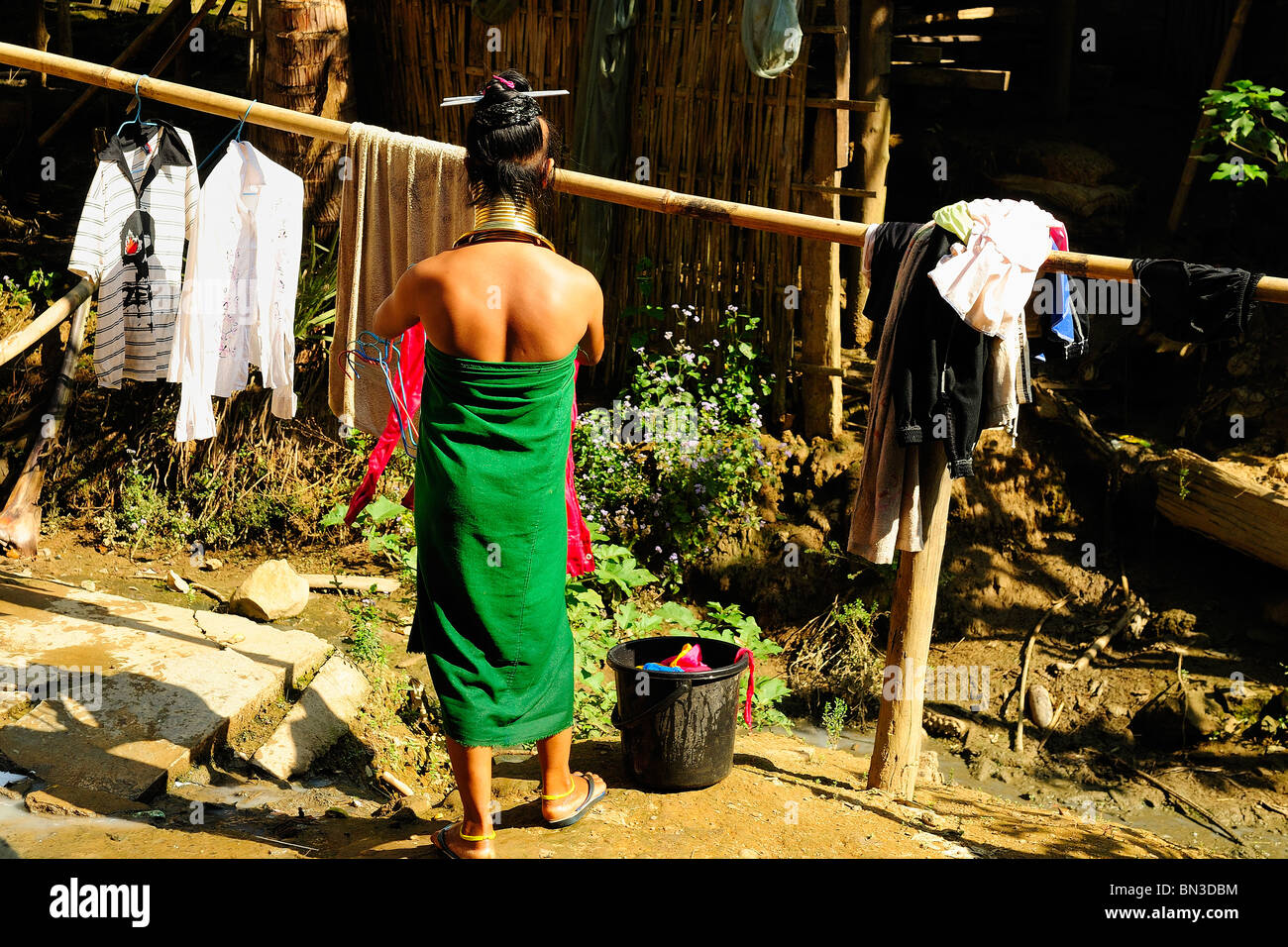 Kayan (ethnic minority) woman also called longneck washing up clothes, Mae Hong Son, Northern Thailand, Asia Stock Photo