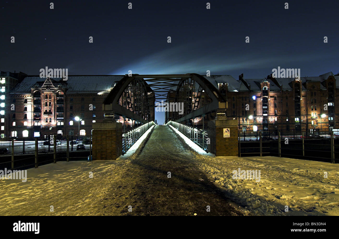 Bridge in the old warehouse district (Speicherstadt) at night, Germany Stock Photo
