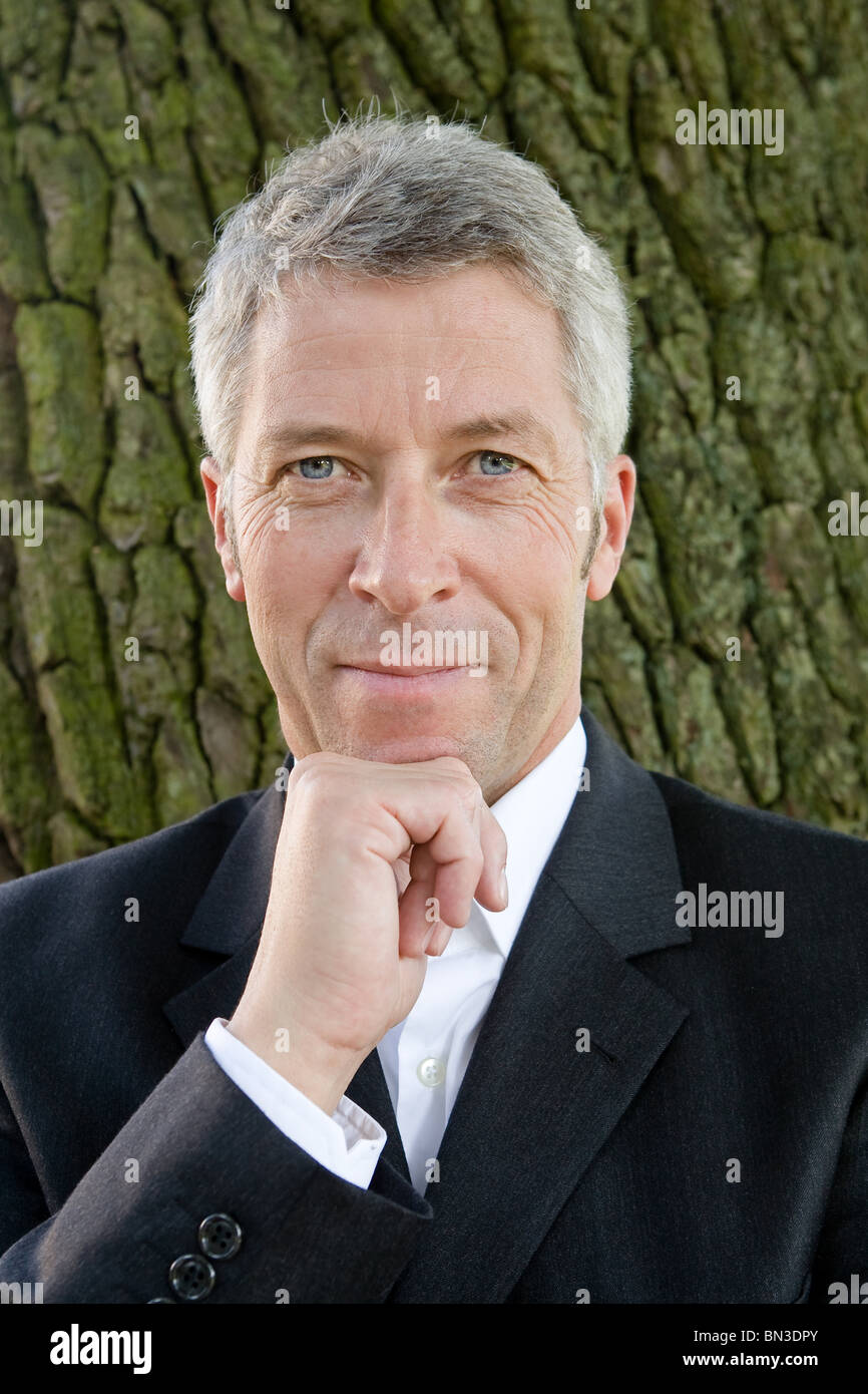 Businessman with hand on chin, portrait Stock Photo