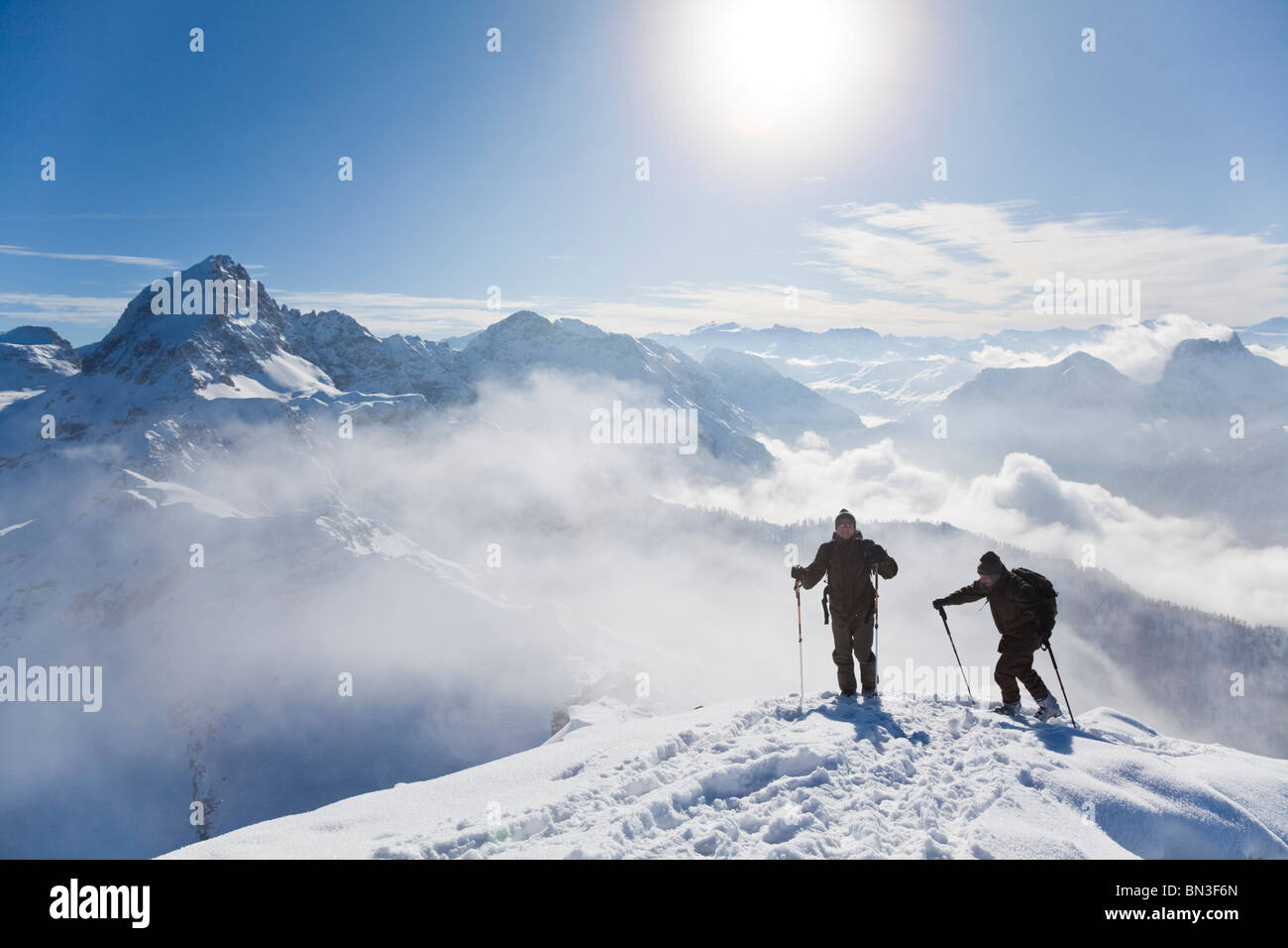 Two ski mountaineers on a mountain peak, Salzburger Land, Austria, elevated view Stock Photo