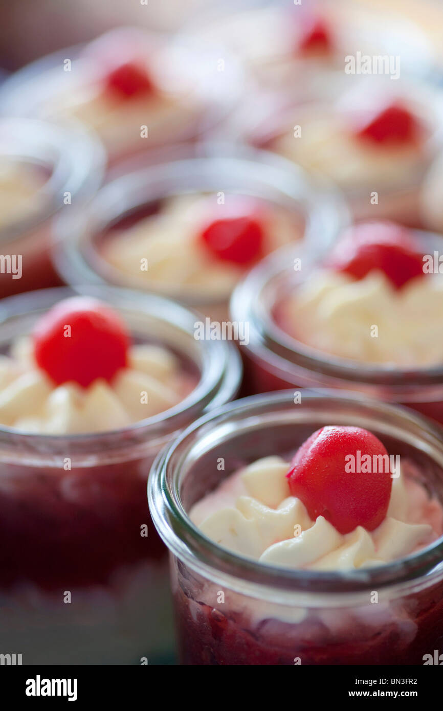 Desserts with whipped cream and cherries, closeup Stock Photo Alamy