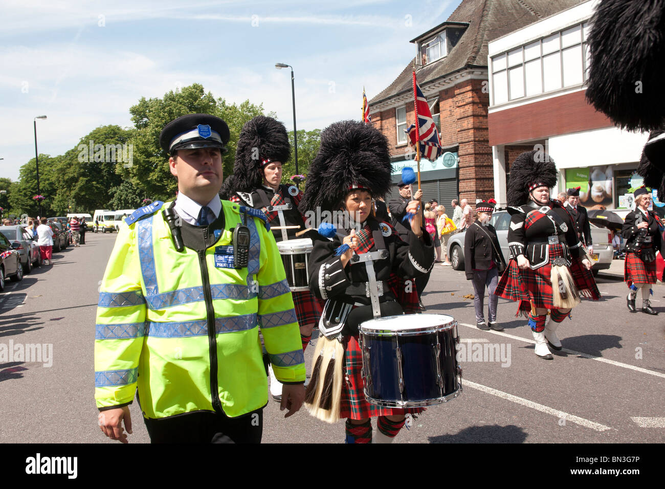 Epping Forest Pipe Band leads the North East London “Armed Forces Day” Parade, Station Road, Chingford, London Borough of Waltha Stock Photo