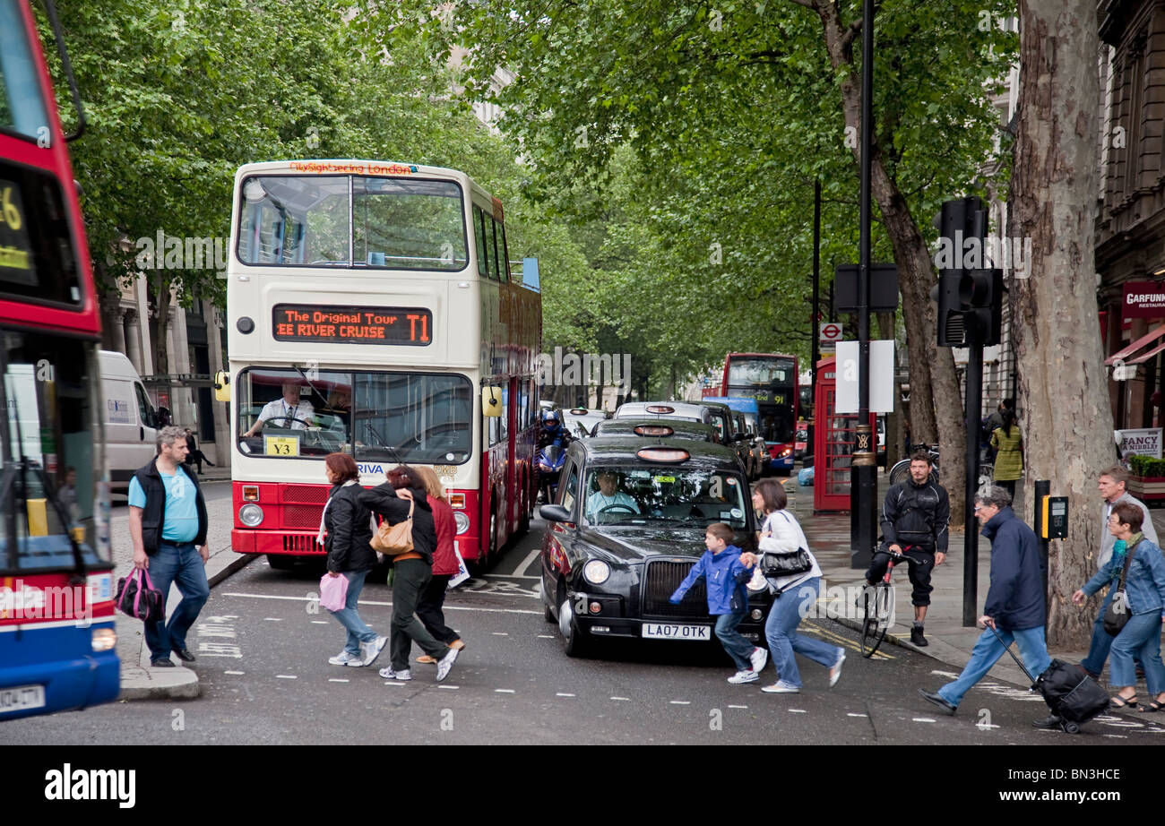 Street scene in the centre of London with black taxi cab and red doubledecker bus, London Stock Photo