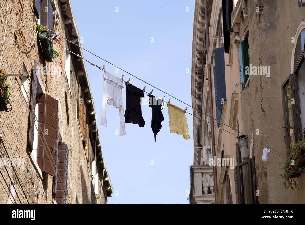 Laundry drying on clotheslines between two buildings, Venice, Italy