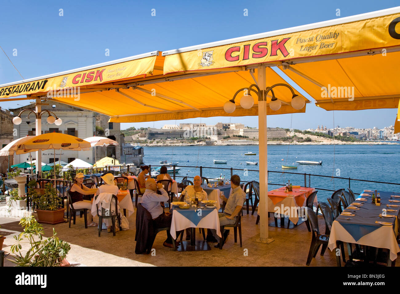 Group of people sitting in a restaurant at the coast, Valletta, Malta Stock Photo