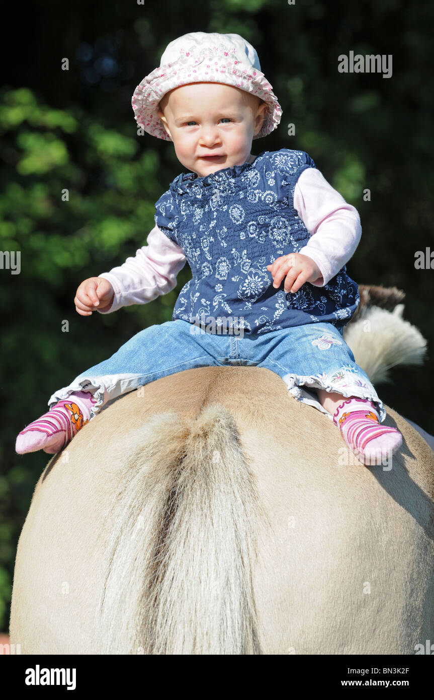 Baby on horse's back Stock Photo - Alamy