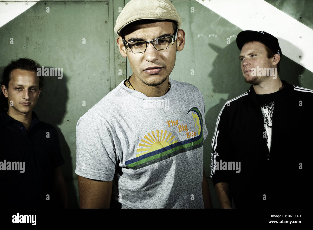 Three young men standing in front of a gate, portrait Stock Photo - Alamy