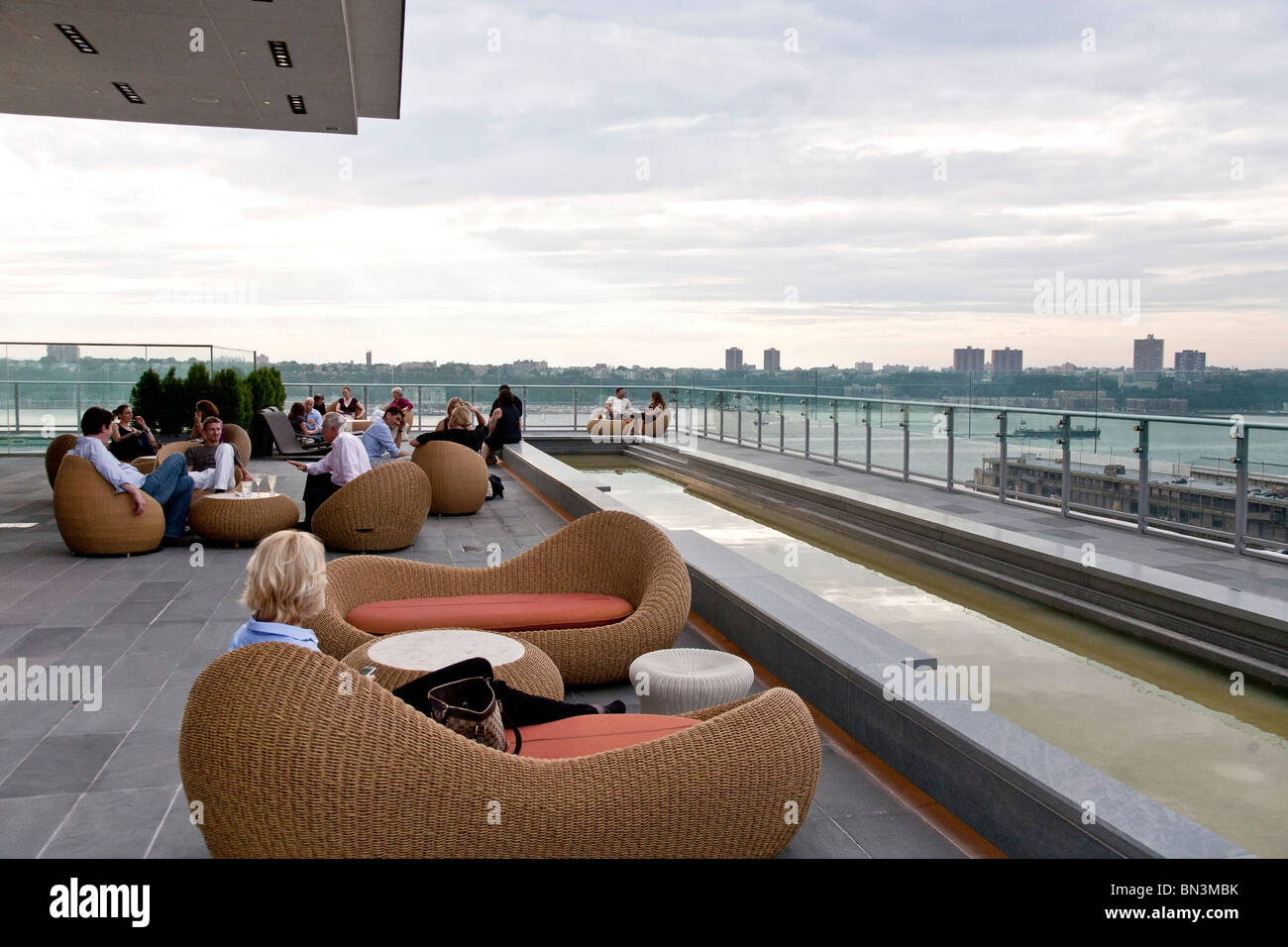 people gathered in informal seating groups enjoying drinks superb