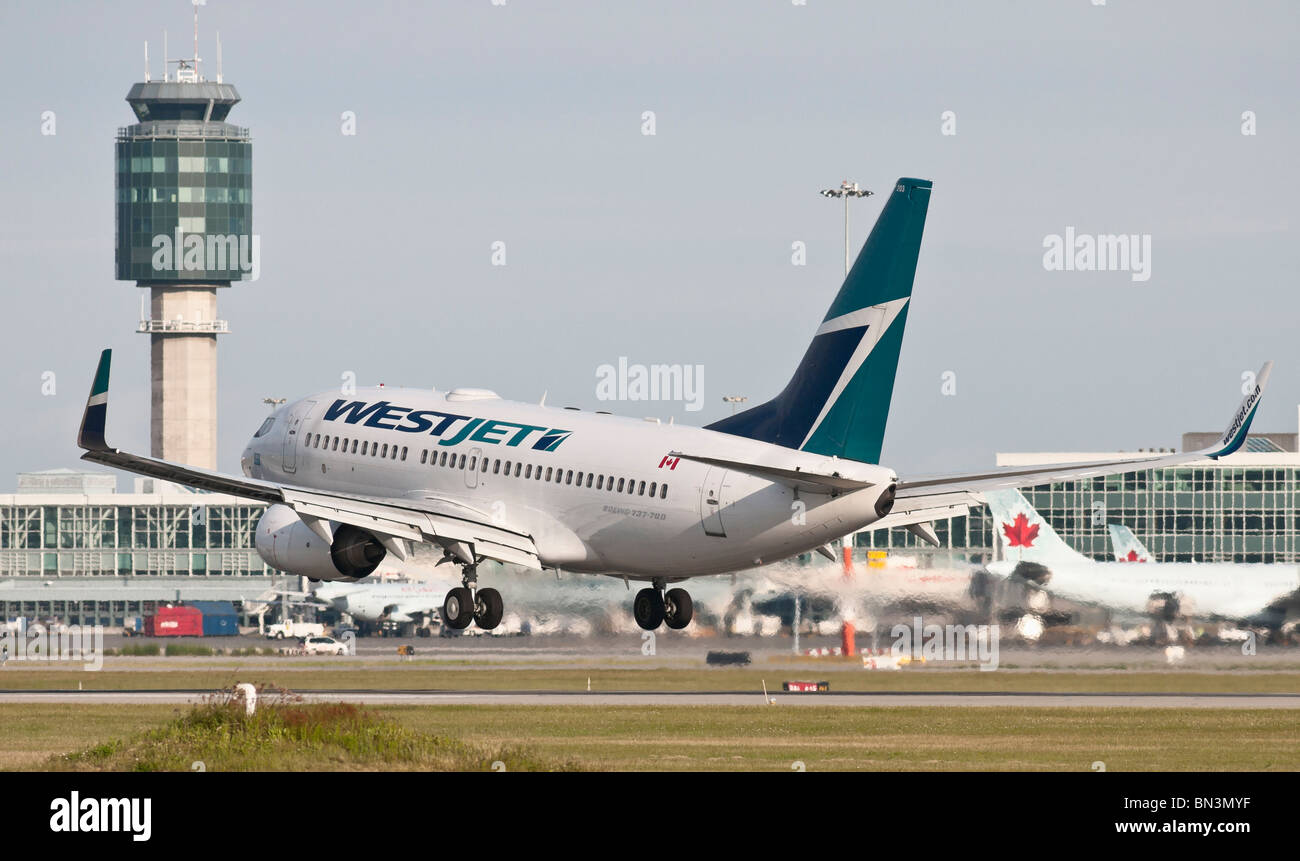 A Westjet Boeing 737-700 Jet Airliner Landing At Vancouver ...