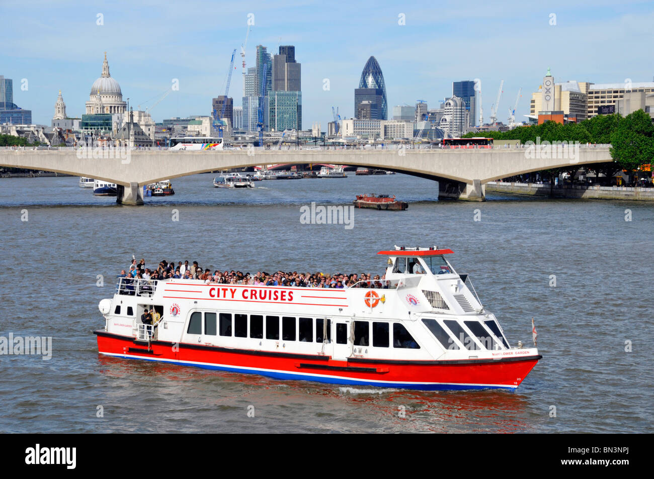 River Thames tour boat Waterloo Bridge and City of London skyline Stock