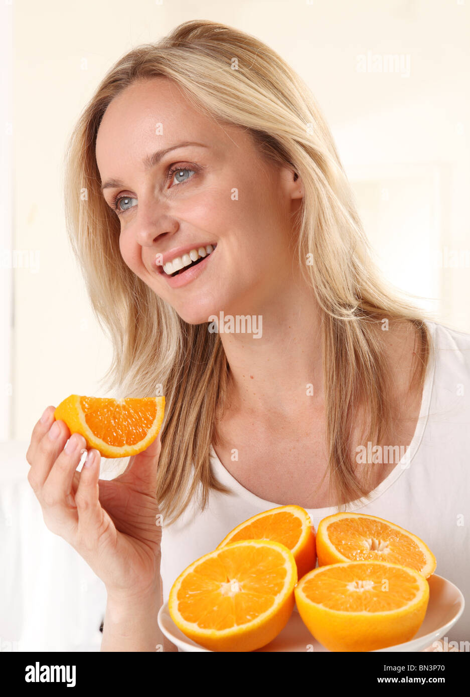 WOMAN EATING ORANGES Stock Photo Alamy