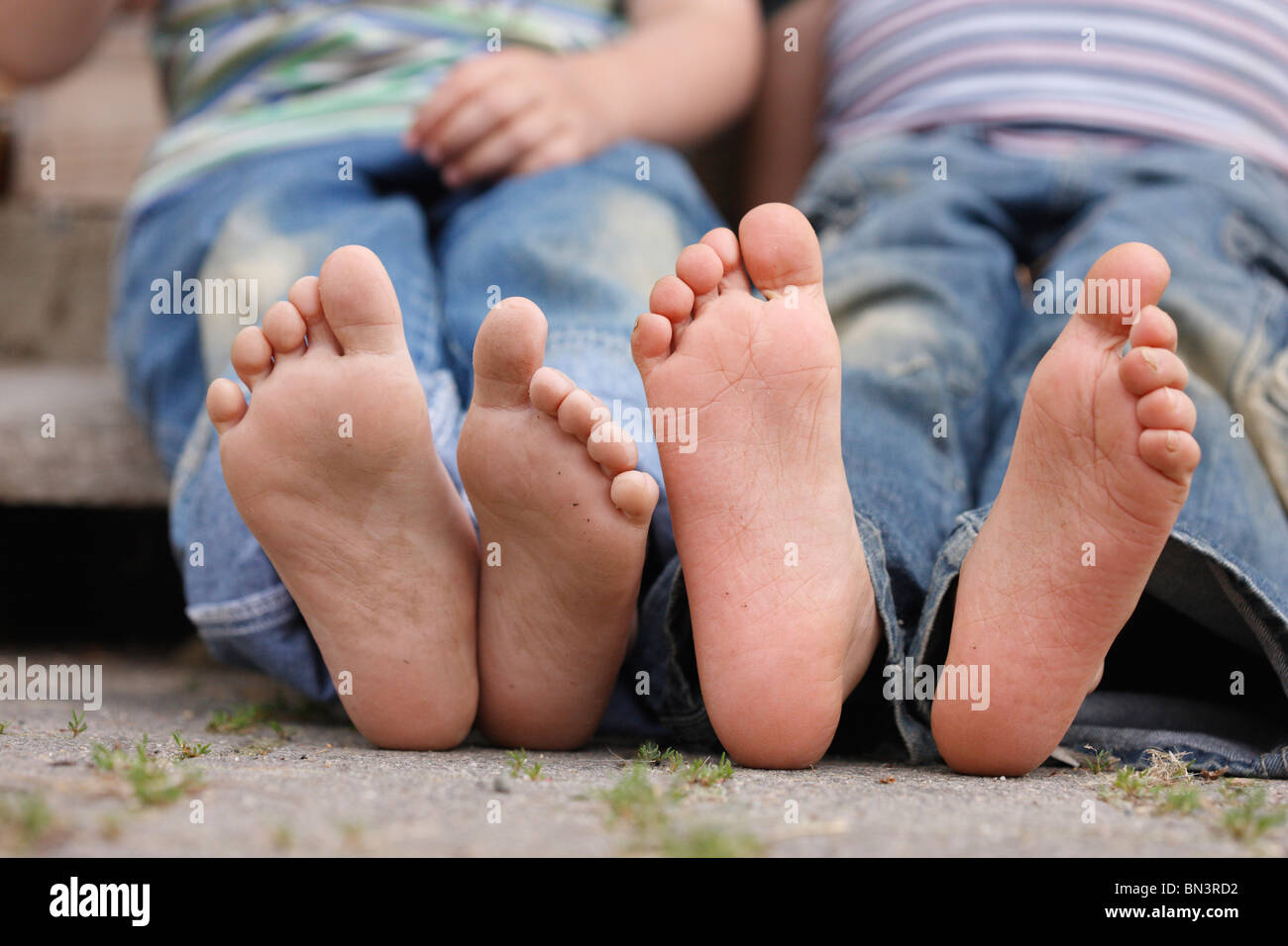 dirty feet of a child from below, Germany Stock Photo
