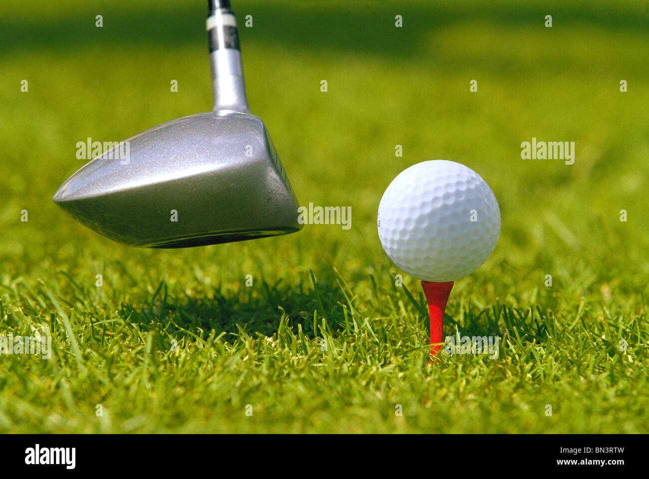 Golf club head hitting golf ball hires stock photography and images