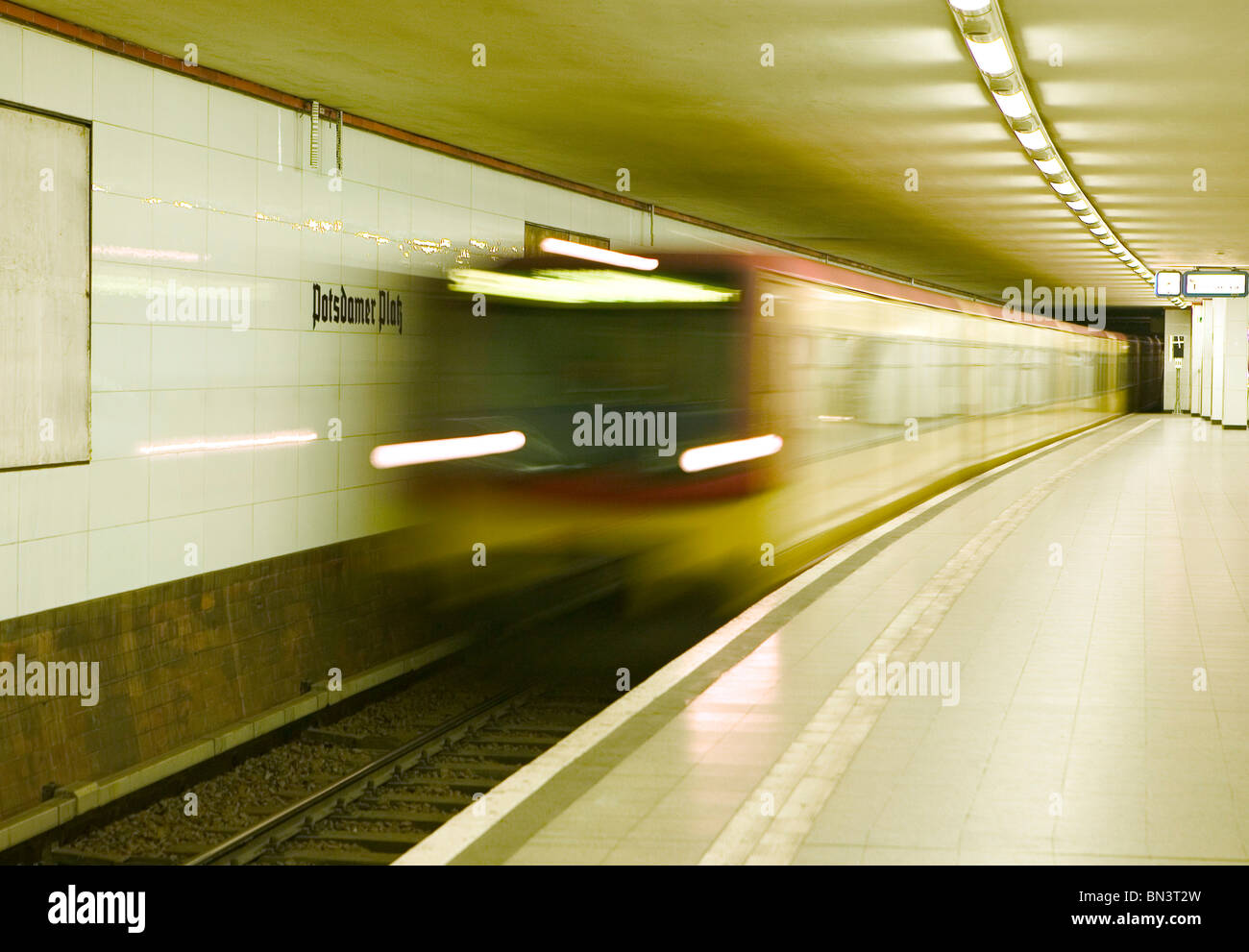 Blurred view of train leaving platform Stock Photo