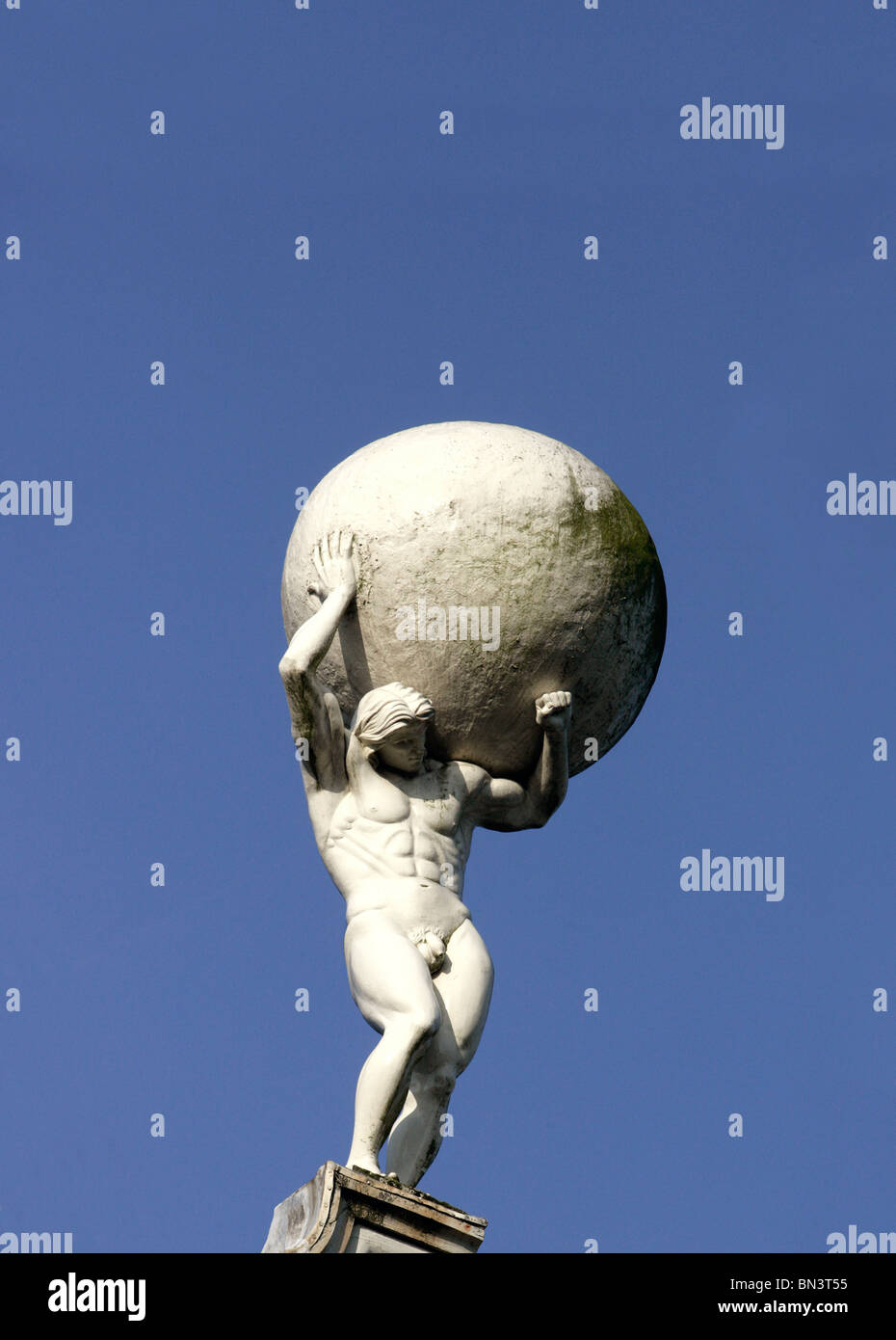 Low angle view of statue of man carrying globe Stock Photo