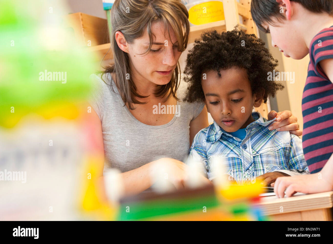 Kindergarten teacher reading children, low angle view Stock Photo