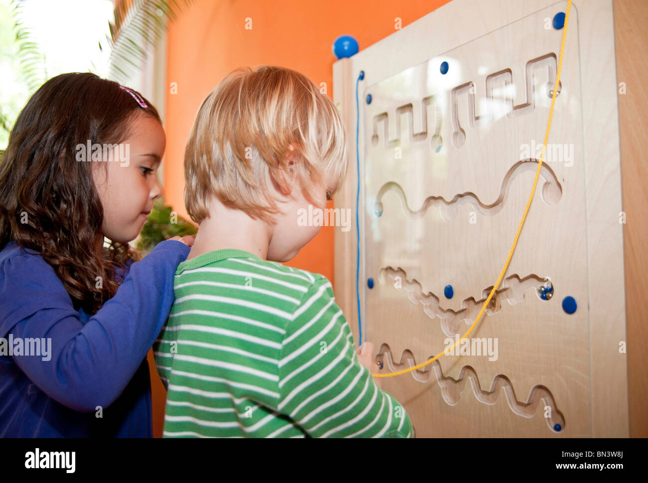 Young boy and girl playing in a kindergarten, low angle view Stock Photo