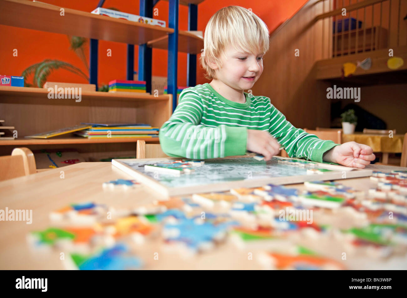 Young boy doing a jigsaw, low angle view Stock Photo Alamy