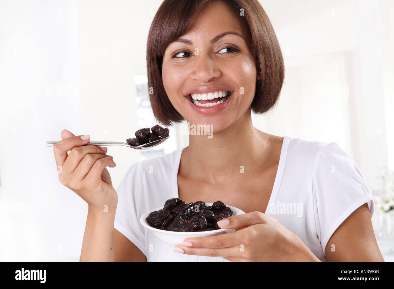 WOMAN EATING PRUNES Stock Photo Alamy