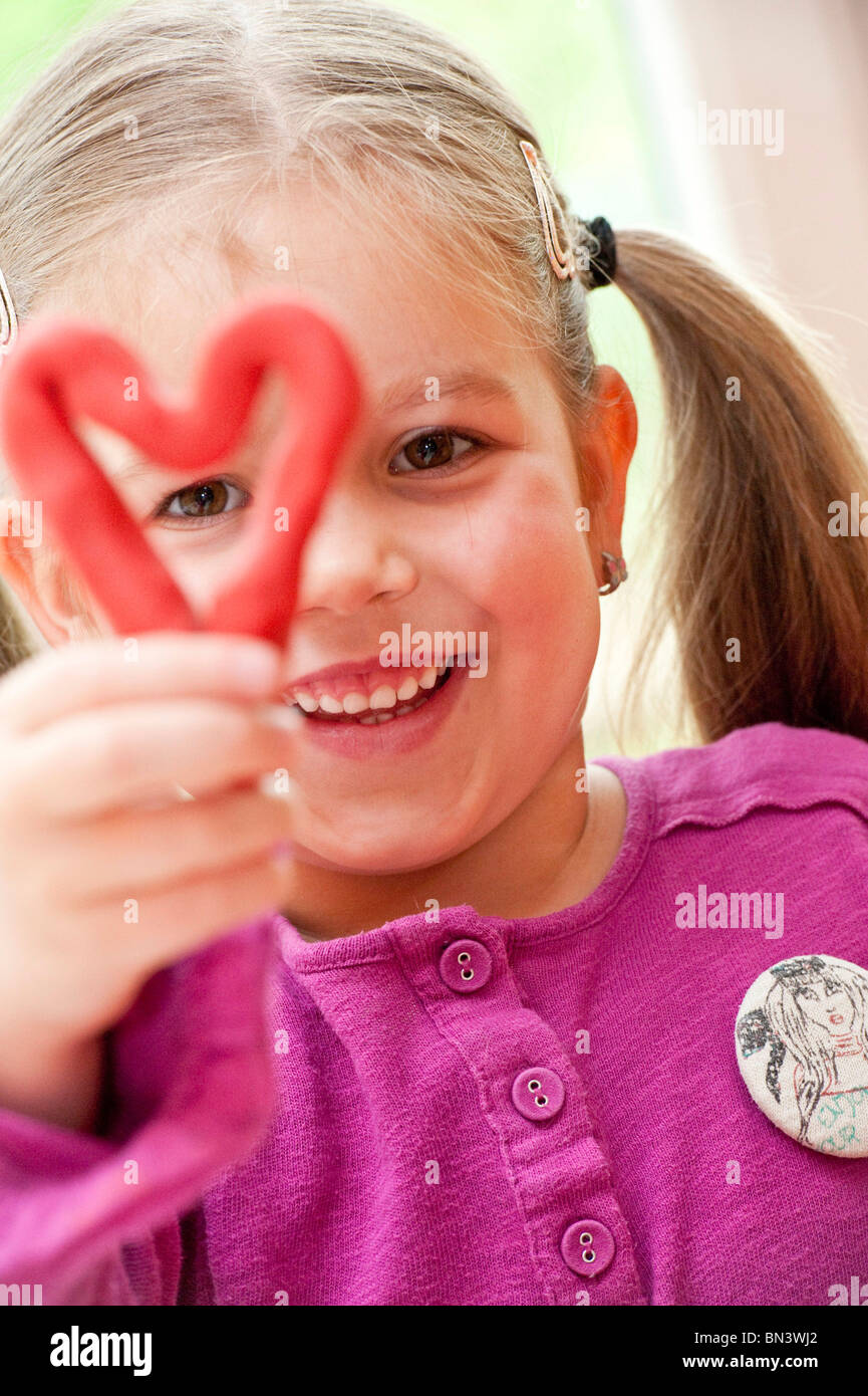Little girl holding a self-made heart, portrait Stock Photo