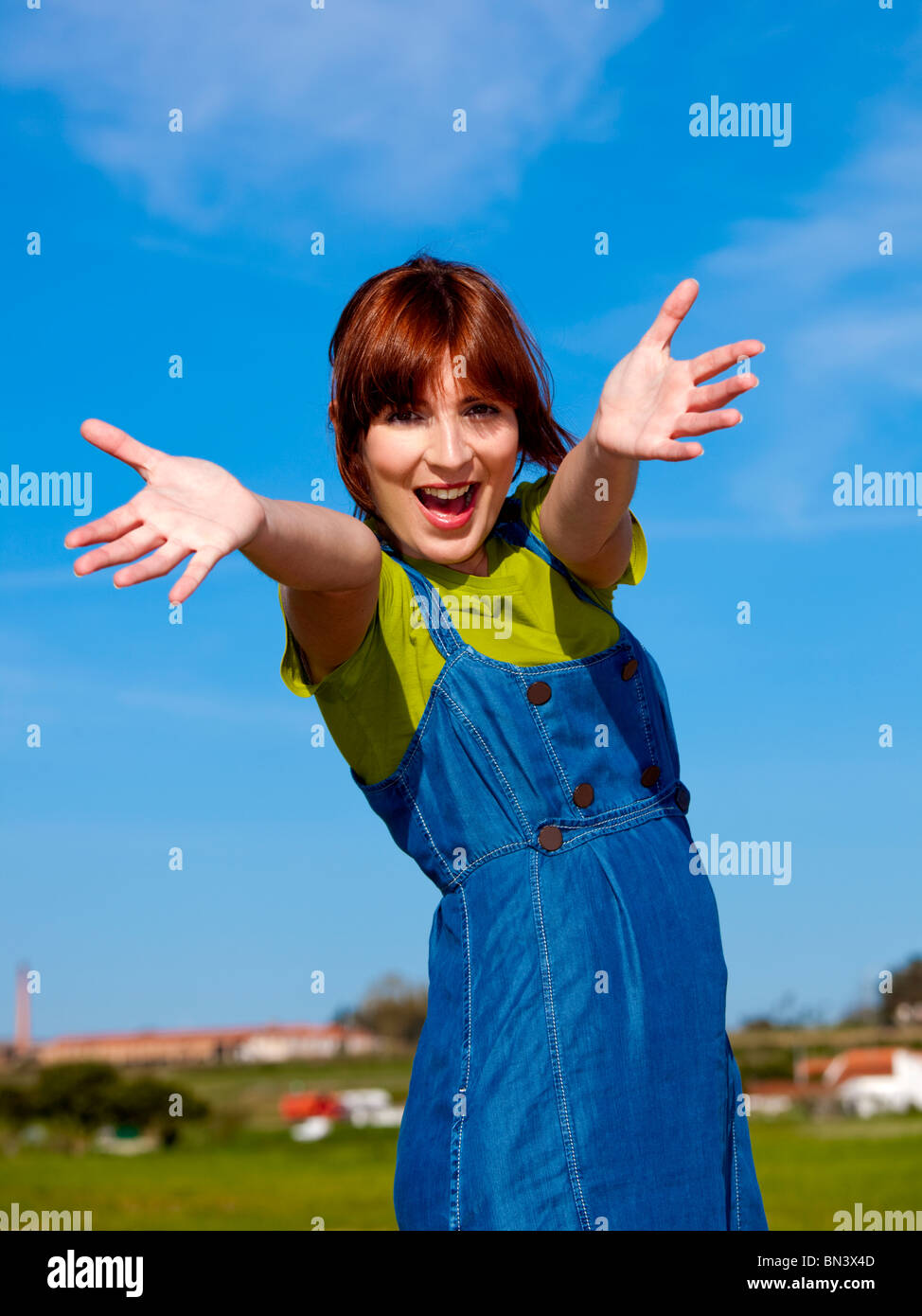 Portrait of a happy beautiful woman over a blue sky Stock Photo - Alamy