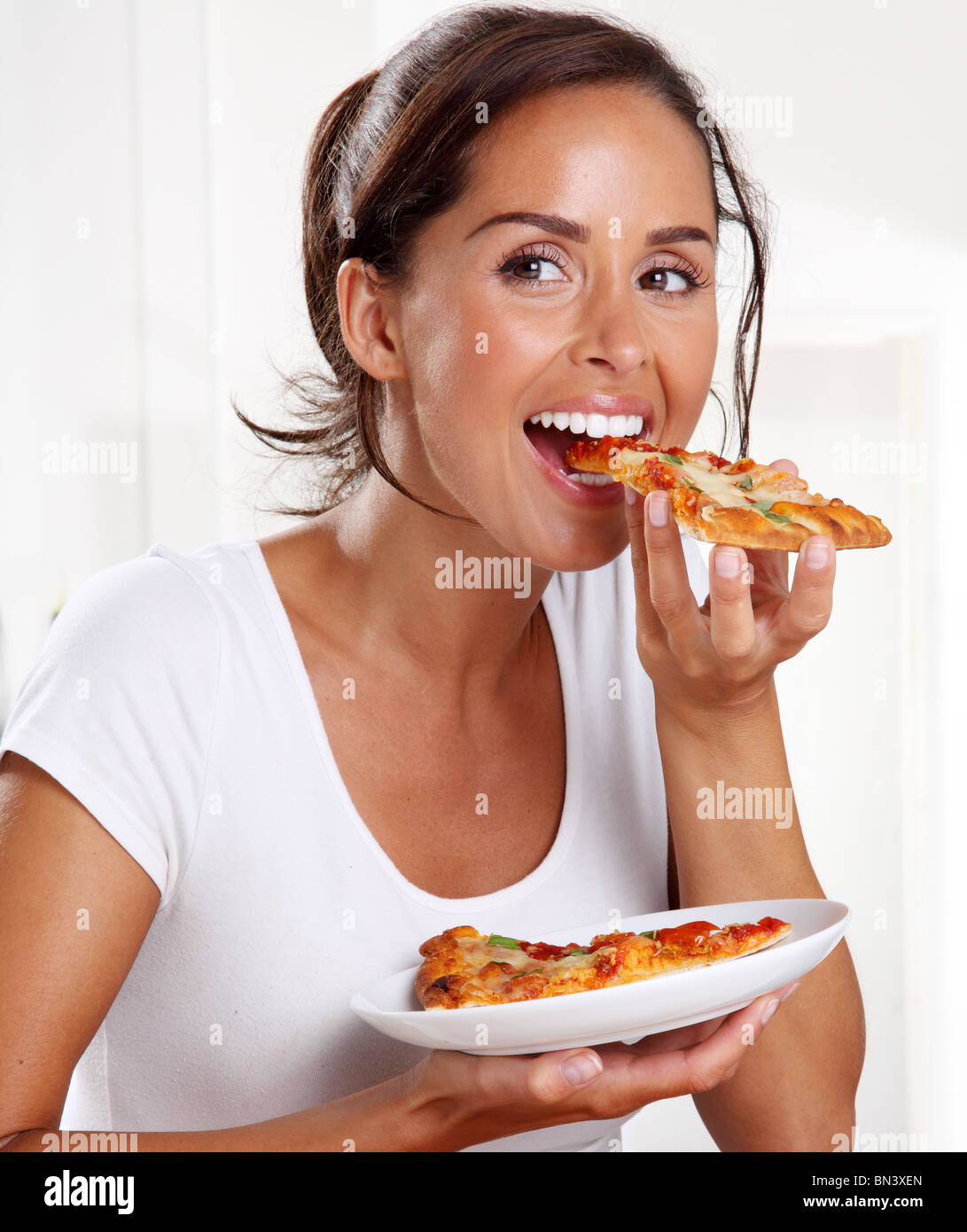 WOMAN EATING PIZZA Stock Photo