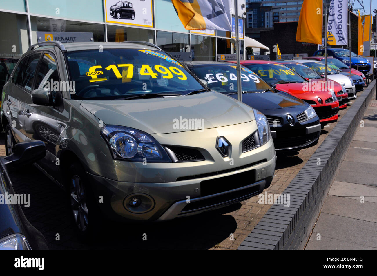 Row of second hand used cars outside Renault car dealer on a pavement forecourt displaying prices of each vehicle Ilford East London England UK Stock Photo