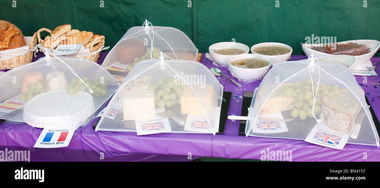 Netted cheeses at a cheese and wine party Stock Photo