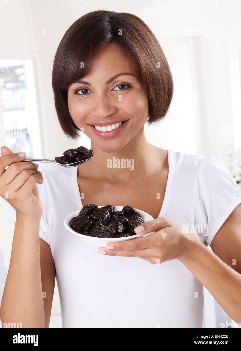 WOMAN EATING PRUNES Stock Photo