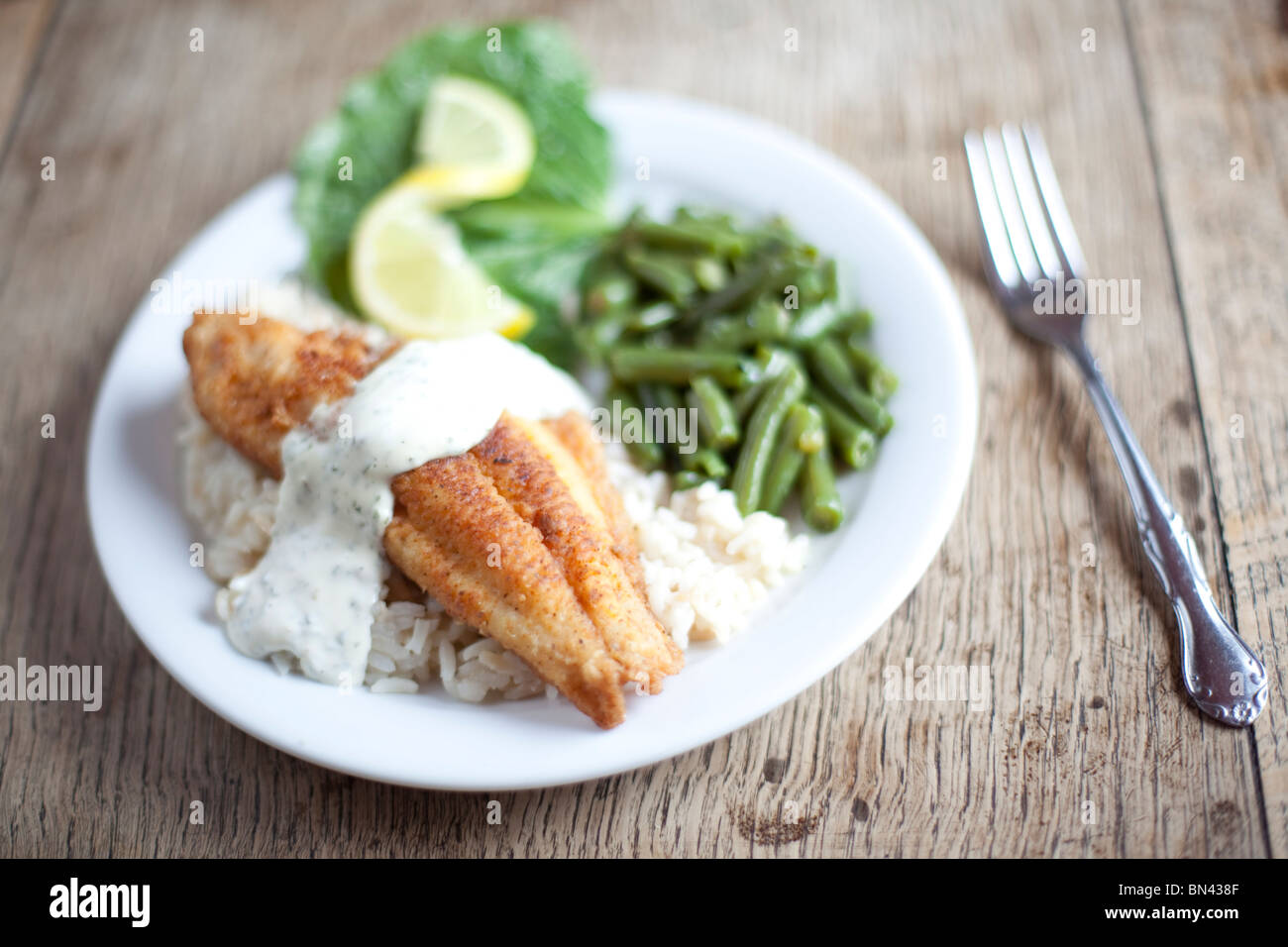 A French-style breading on local catfish served with green beans. Shot at The Crown Restaurant, Indianola, Mississippi. Stock Photo