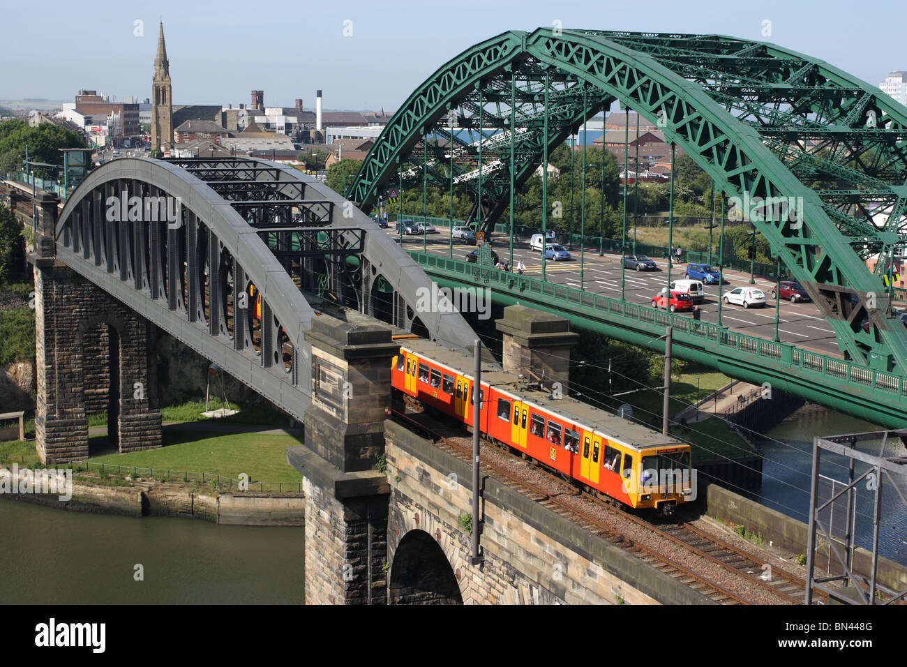 A Tyne and Wear Metro train heads south over the Wearmouth railway bridge in Sunderland, England, UK Stock Photo