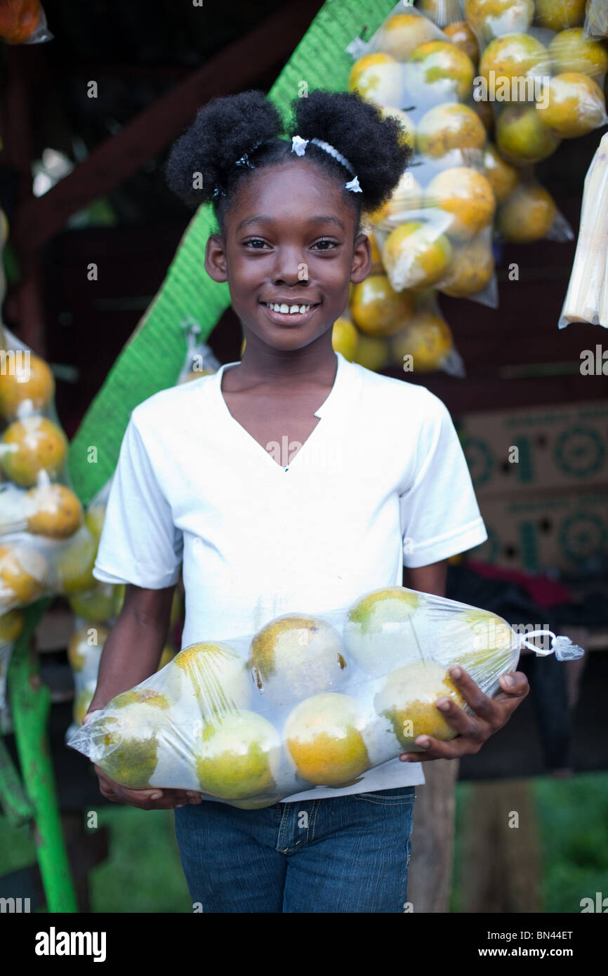 Portrait of Sabrina, the daughter of the owner of the fruit stand along a highway in Jamaica. Stock Photo