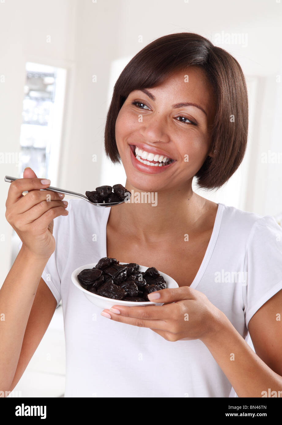 WOMAN EATING PRUNES Stock Photo Alamy