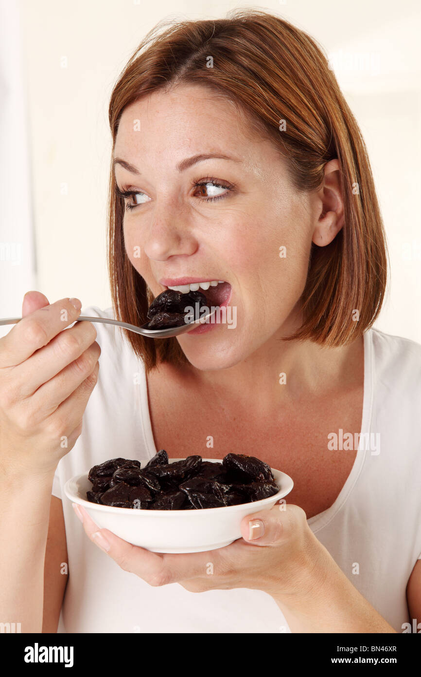 WOMAN EATING PRUNES Stock Photo